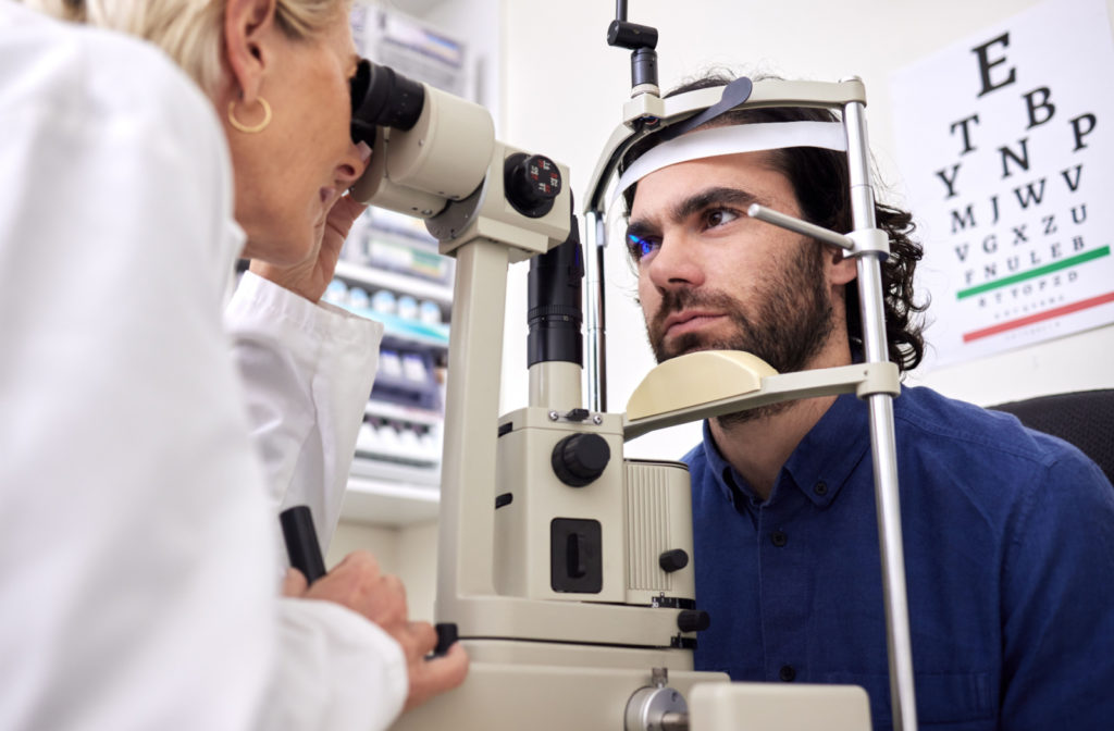 A young man undergoing a slit lamp test as a part of his eye examination.