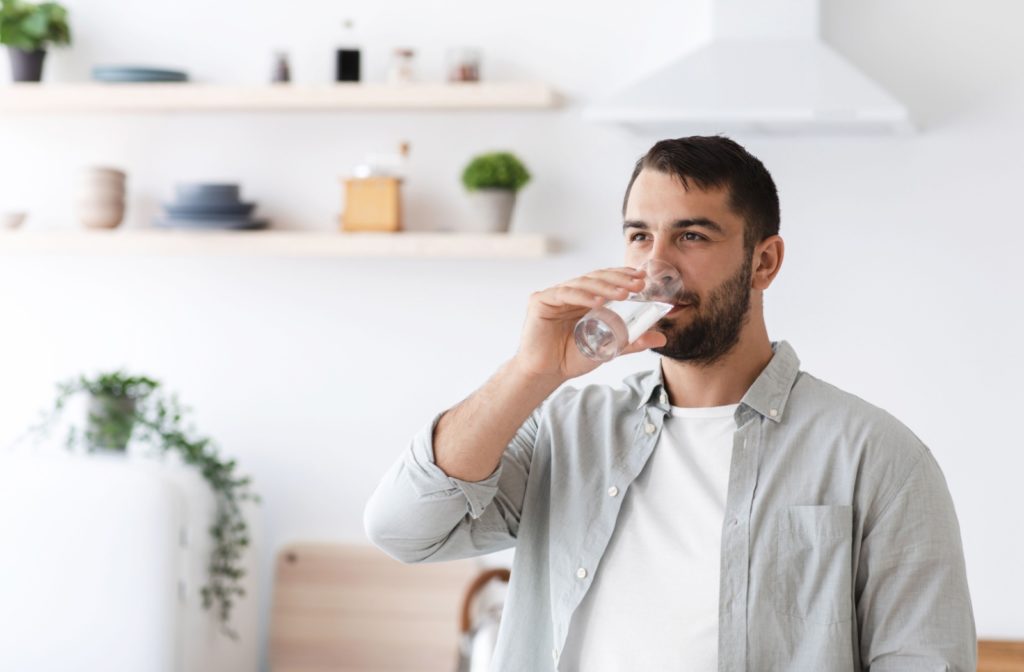 A man drinking water from a glass.